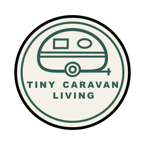 A circular logo featuring a dark green retro caravan illustration and the text 'TINY CARAVAN LIVING' on a white background.