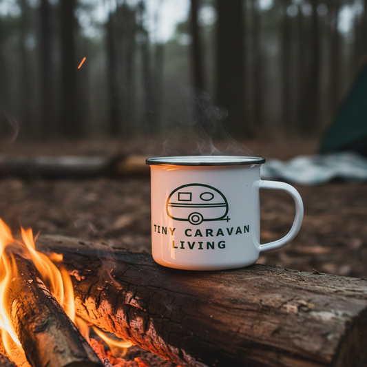 Green Tiny Caravan Living caravan logo on an enamel mug around a campfire setting